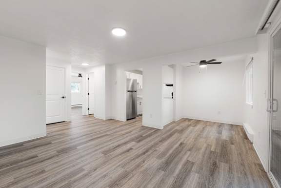 A room with wooden flooring and white walls.
