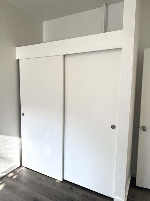 Bedroom closet with sliding doors and upper storage space in Olympia Washington apartment