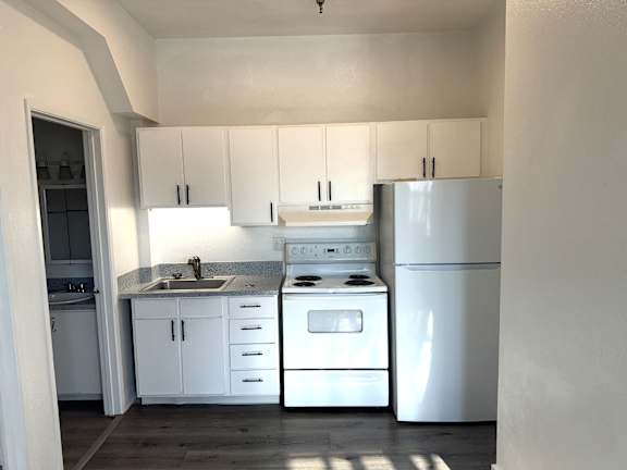 Kitchen with white appliances, cabinets, and countertops in Olympia WA apartment
