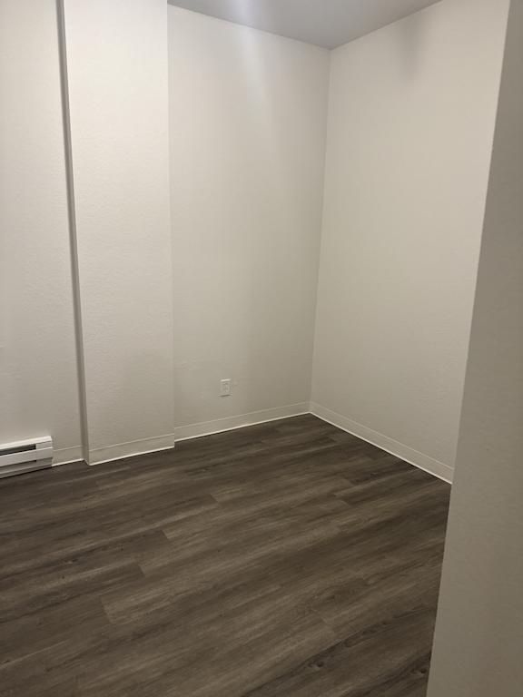 Bedroom with wood-style flooring and neutral walls in 2bedroom home at The Elks Apartments in Olympia WA apartment