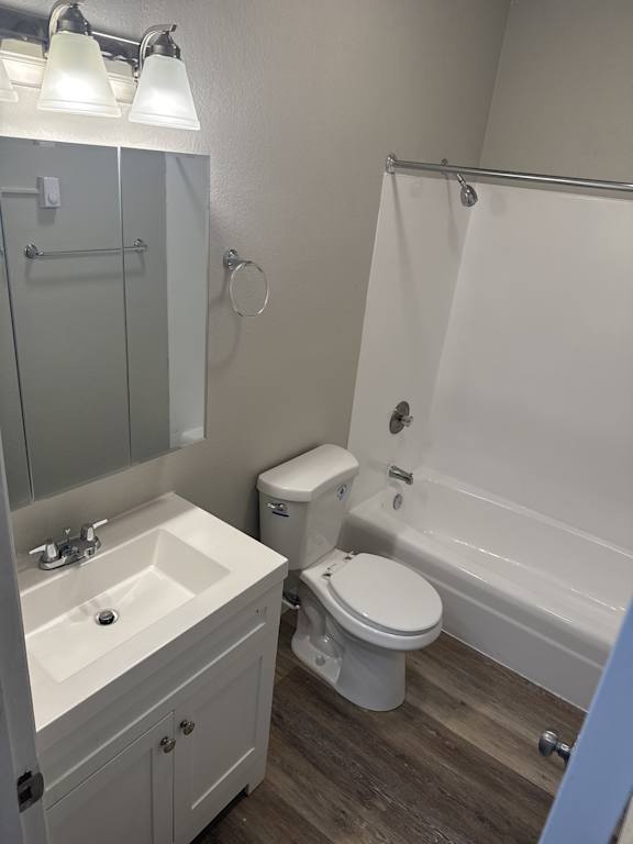 A white toilet sits next to a sink in a small bathroom.