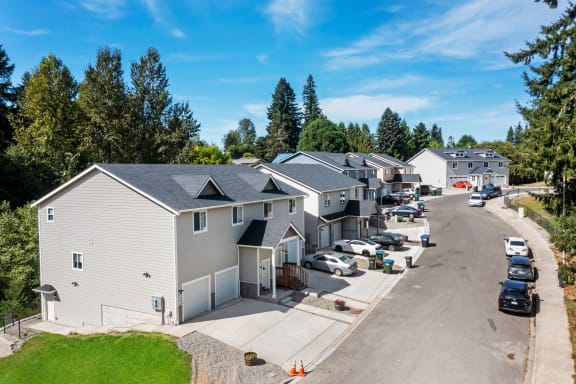 a row of houses with cars parked in front of them