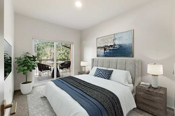 A bedroom with a large bed and a painting on the wall.