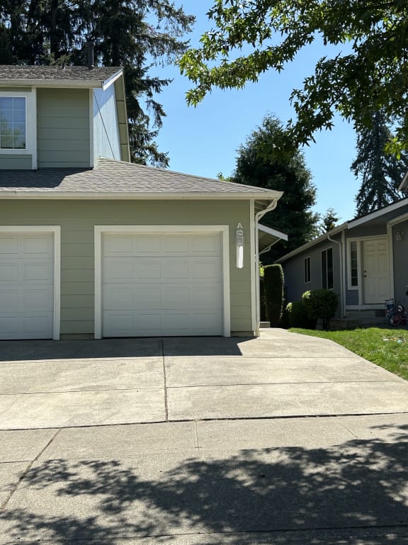 a house with a white garage door and a driveway