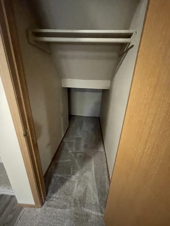 the bottom of a stairwell in a building with a glass door