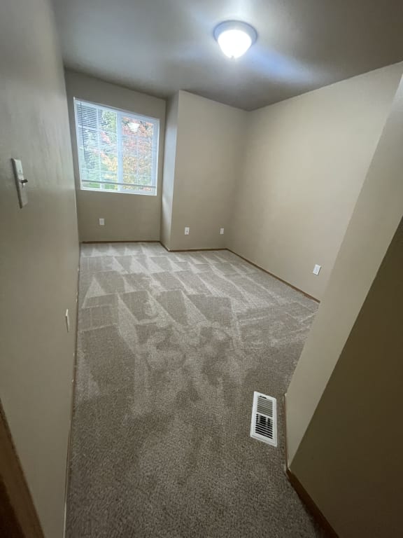 the living room has a stone wall and a window