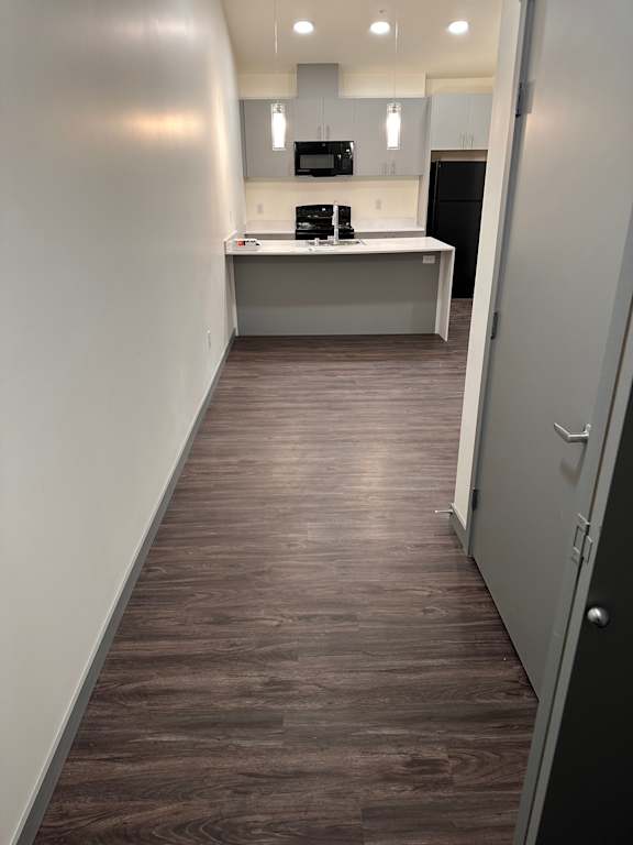 a wood paneled wall in an empty room with a white floor
