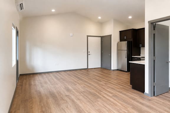 A kitchen area with a refrigerator and cabinets.