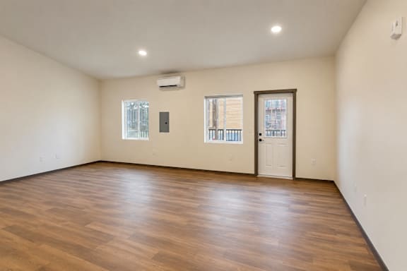A room with wooden floors and a white door.