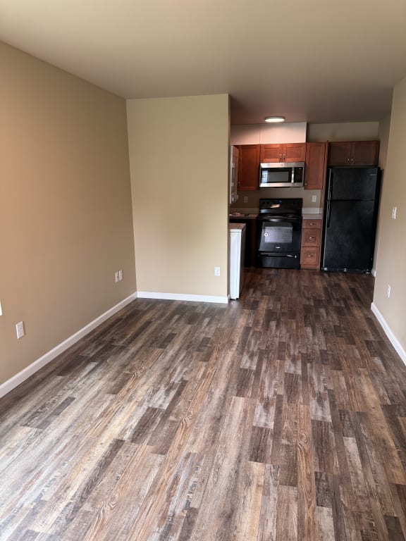 a view of the kitchen and living room from the bottom of the stairs