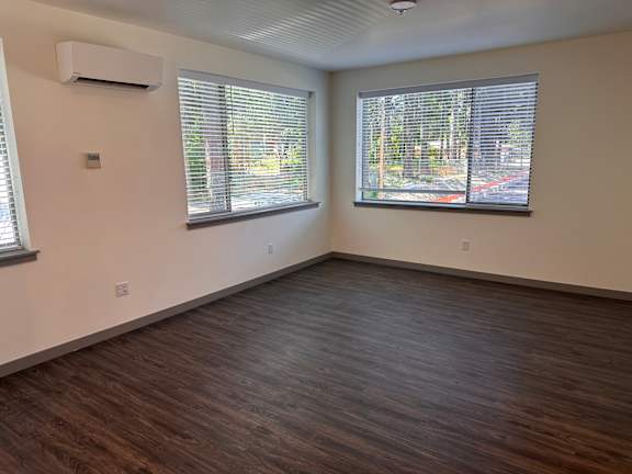 an empty room with three windows