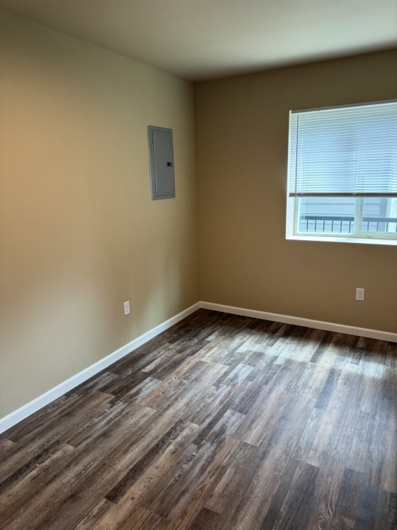 an empty room with a door and a window