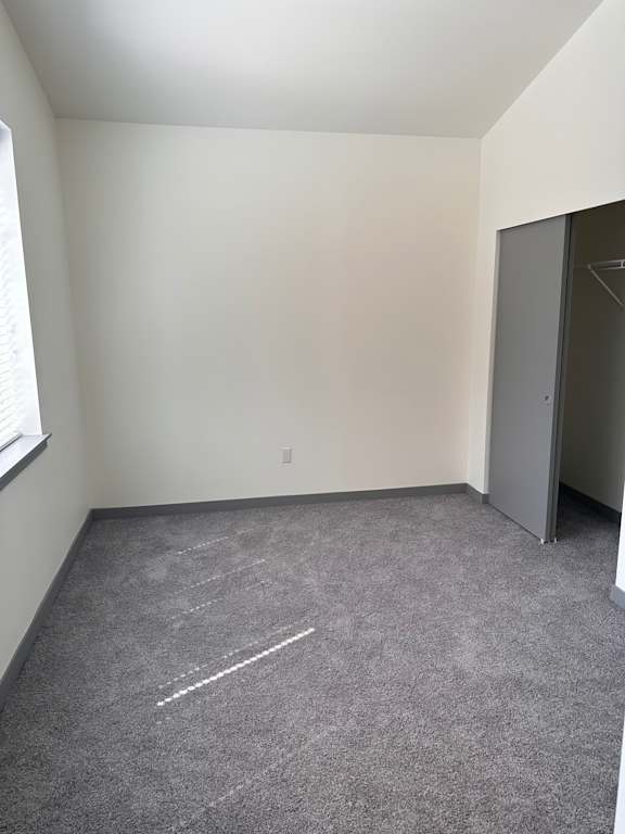 a small room with white walls and a concrete wall