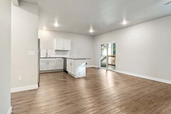 the living room and kitchen in a bedroom plus den unit at the casey, 2100 del