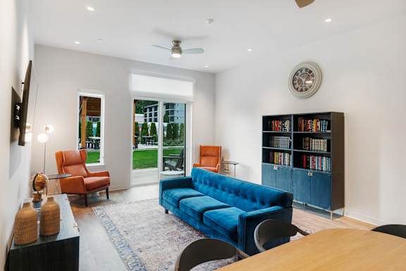 A living room with a blue couch at The Hub Apartments, Lacey