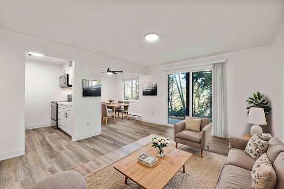 A living room with a brown sofa and a wooden coffee table.