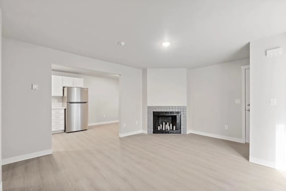 A living room with a fireplace and a balcony.