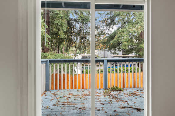 A view of a balcony with a blue railing and orange fence.