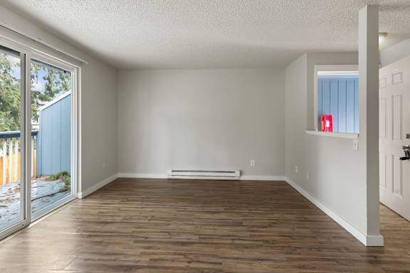 A room with wooden floors and white walls.
