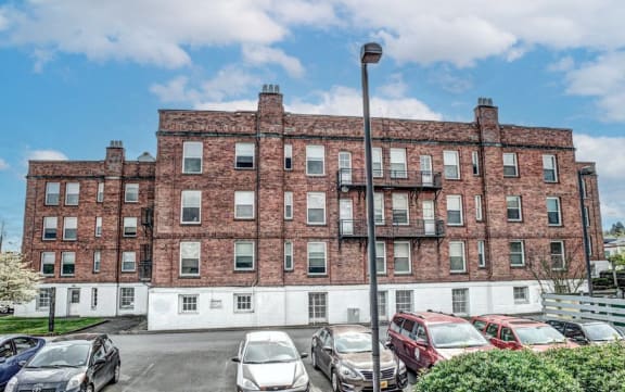 a brick building with cars parked in front of it