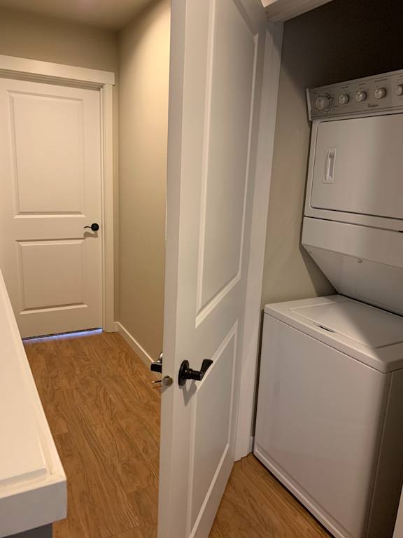 A white door with a black handle is in the bottom right corner of the image.