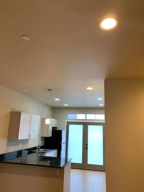 A room with a white wall and a round light fixture.