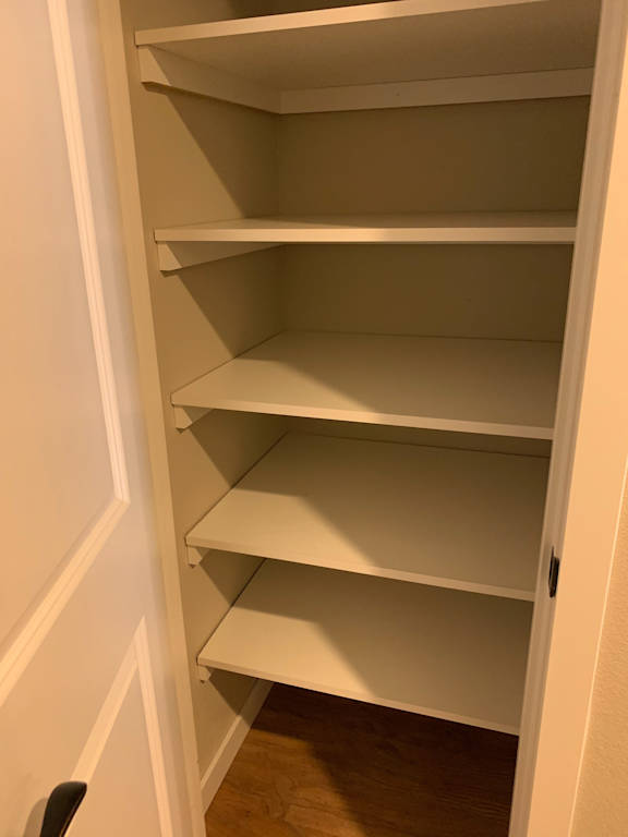 A white shelf with four compartments is empty.