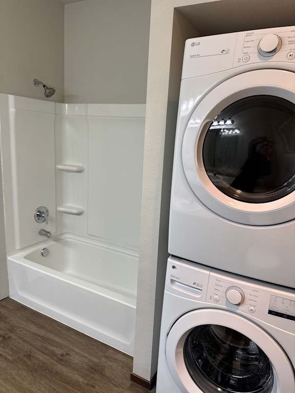 A white washing machine and dryer are installed in a wall.
