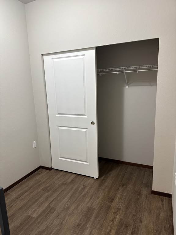 A white cupboard with two doors is mounted on a wall.