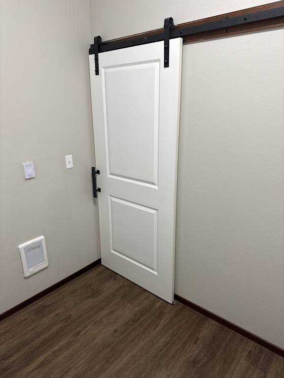 A white door with a black handle is open.