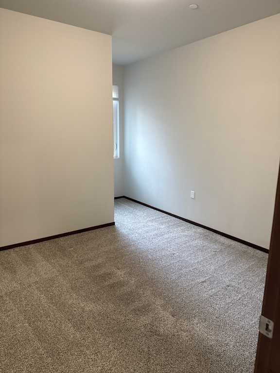 A room with a light on the ceiling and a wall with a brown texture.