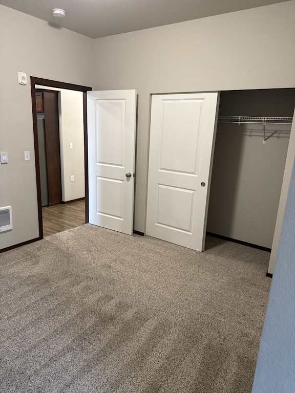 A white cabinet with a drawer is in the corner of a room.