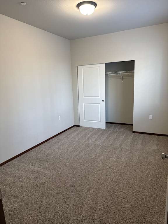 A white door is in a room with a brown wall.