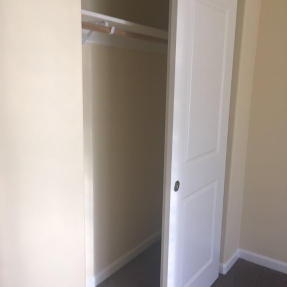 A white door with a black knob is open.