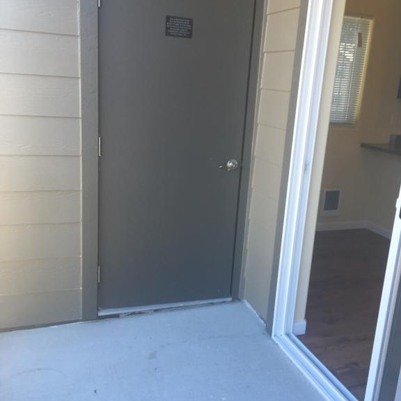 A white door with a handle is open.