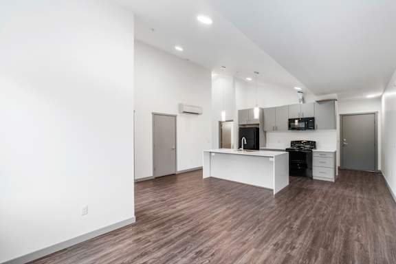 A spacious kitchen with a white countertop and a refrigerator.