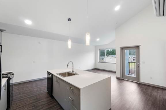 A modern kitchen with a sink and a window.