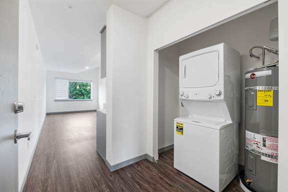 A white appliance is in a room with a grey floor.