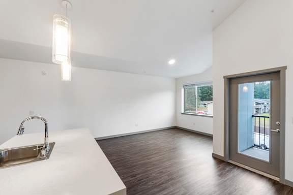A modern kitchen with a sink and a window.