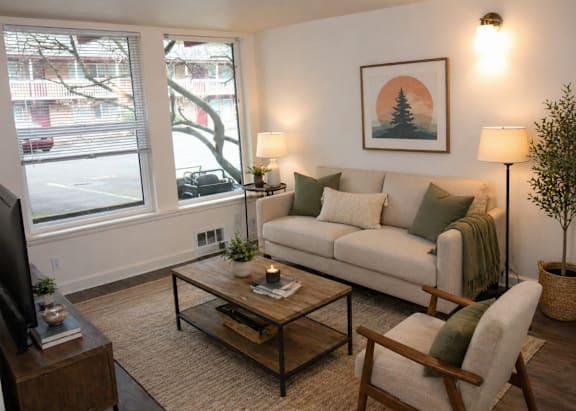 A living room with a couch, chair, and coffee table.