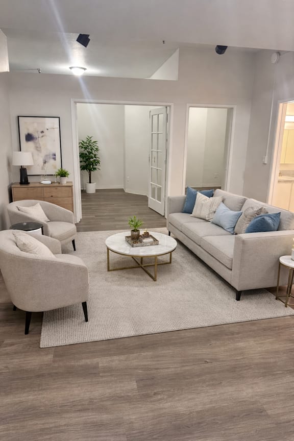 Virtually staged living room with sofa and chairs in Olympia Washington apartment
