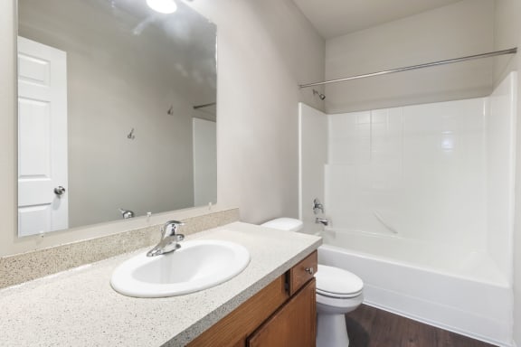 3x2 a bathroom with a sink toilet and shower and a mirror