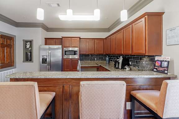 a kitchen with granite counter tops and wooden cabinets at Cumberland Place Apartment Homes, Tyler 75703