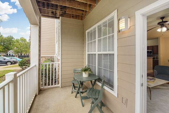 A small balcony with a table and chairs at Highlands Apartment Homes, Bartlett, 38135