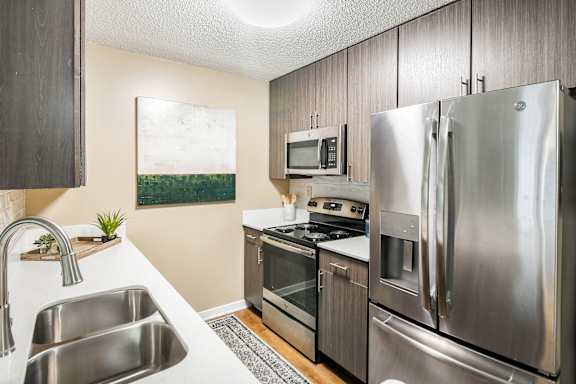 A modern kitchen with stainless steel appliances at Crossgates Apartment Homes, Starkville