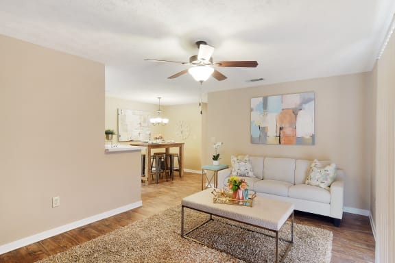 a living room with a couch and a coffee table  at Parklane Apartment Homes, McComb