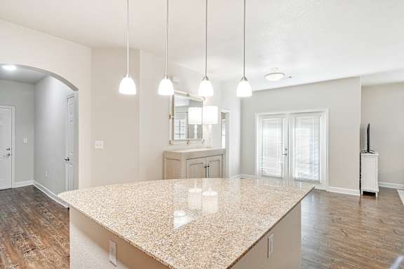 A kitchen with a granite countertop and pendant lights at Faulkner Flats Apartment Homes, Mississippi&#xA0;, 38655