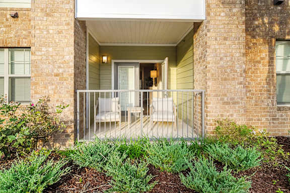 Balcony with a white railing at Faulkner Flats Apartment Homes, Oxford, Mississippi