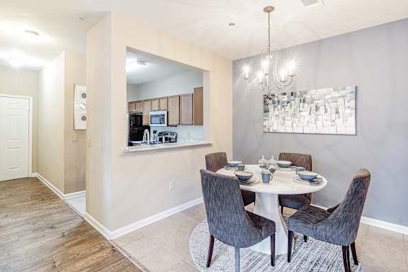 A dining room with a table set for four at The Vineyard of Olive Branch Apartment Homes, Olive Branch, MS