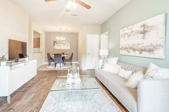 living room with a white couch and a glass coffee table at The Vineyard of Olive Branch Apartment Homes, Mississippi